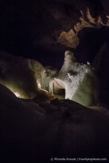 Dark section of the cave with some illuminated ice.