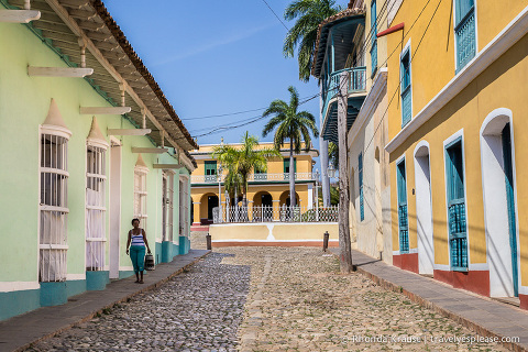 Cobblestone street framed by colourful architecture in Trinidad.