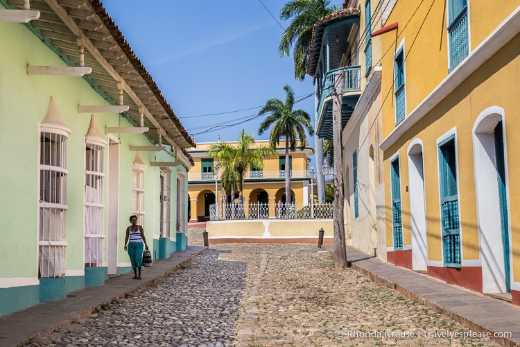 Cobblestone street framed by colourful architecture in Trinidad.