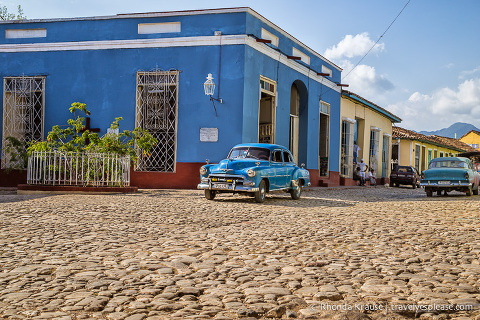 American classic car on a cobblestone street in Trinidad.