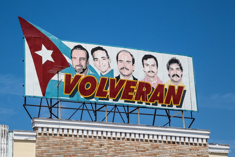 Billboard with the faces of five men.