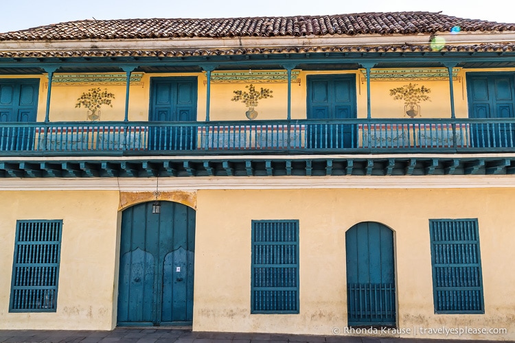 Yellow building with blue windows and doors.
