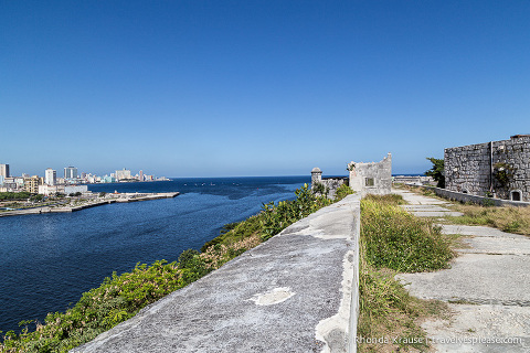 Stone wall of La Cabaña with Havana in the background.