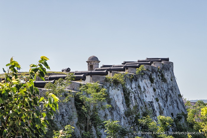 Canons pointing off a high wall of Fortaleza de San Carlos de la Cabaña.