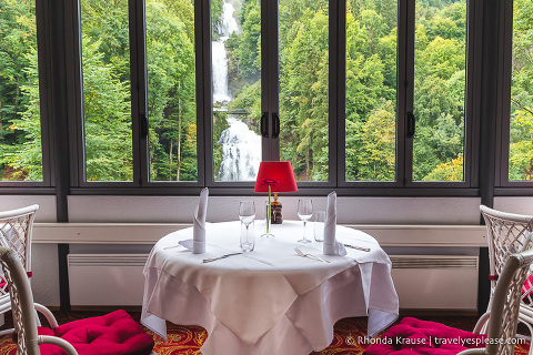 Restaurant table with a view of Giessbach Falls inside Grandhotel Giessbach