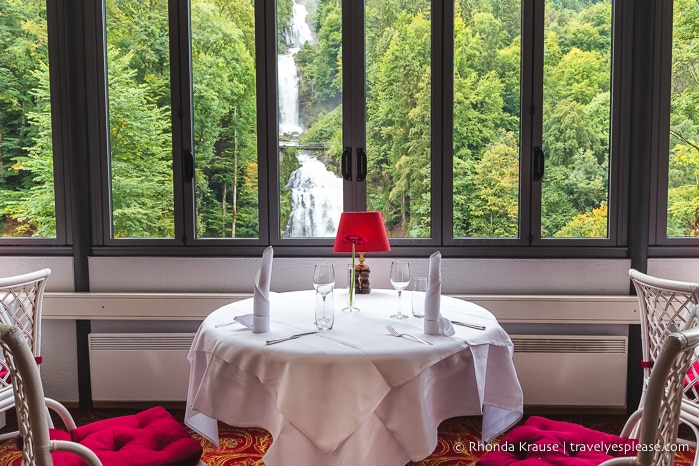 Restaurant table with a view of Giessbach Falls inside Grandhotel Giessbach