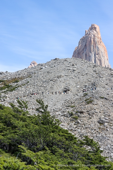 One of the towers behind a large pile of rock.