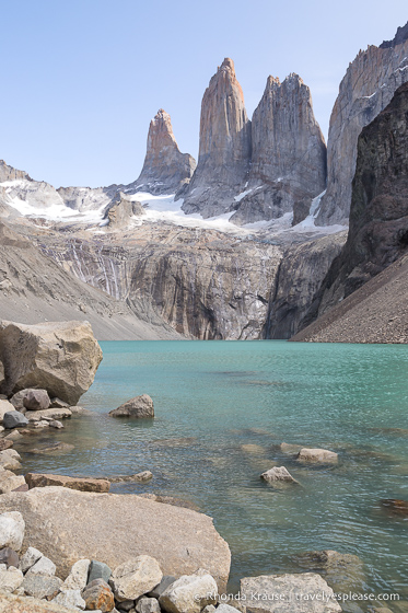 The towers, Torres del Paine, overlooking a small turquoise lake.