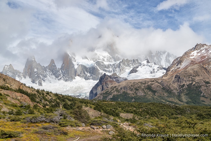 Mount Fitz Roy partially covered by clouds.