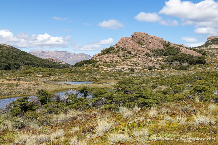 River flowing towards a rocky hill.