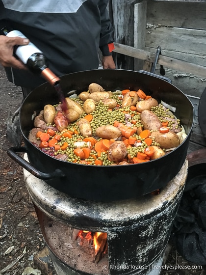 Pot of dinner being cooked over the fire.