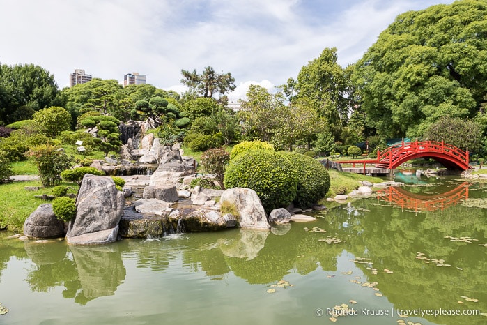 Waterfall, pond, and arched bridge at the Buenos Aires Japanese Garden.