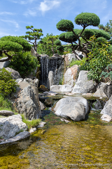 Small waterfall and stream framed by rocks.