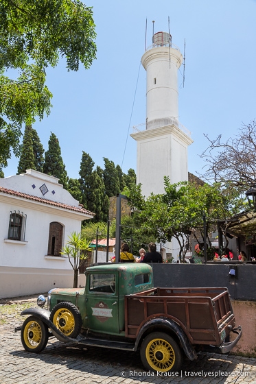 Antique truck parked in front of the Colonia del Sacramento lighthouse.