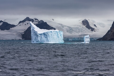 Iceberg floating in front of a glacier.