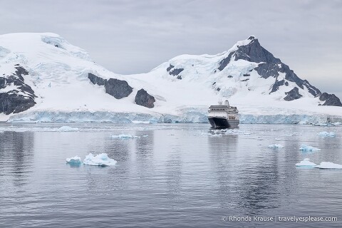 Antarctica cruise ship sailing in front of a glacier.