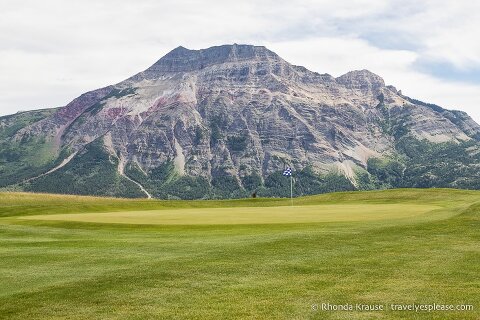 Mountain behind a green at the Waterton Lakes Golf Course.