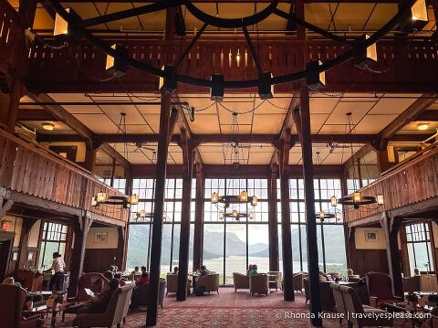Lobby of the Prince of Wales Hotel with large windows looking out on Upper Waterton Lake.