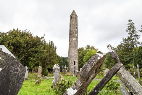 Round tower and tombstones at Glendalough, a popular archaeological site in Ireland.
