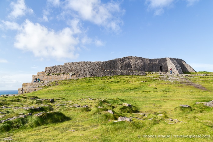 Dún Aonghasa stone fort on a cliff overlooking the ocean.