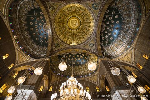 Golden domes and hanging lights inside the Mosque of Muhammad Ali.
