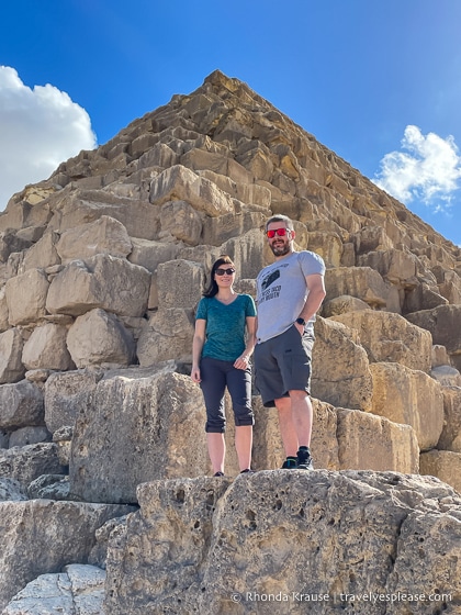 Couple standing in front of the Great Pyramid of Giza.