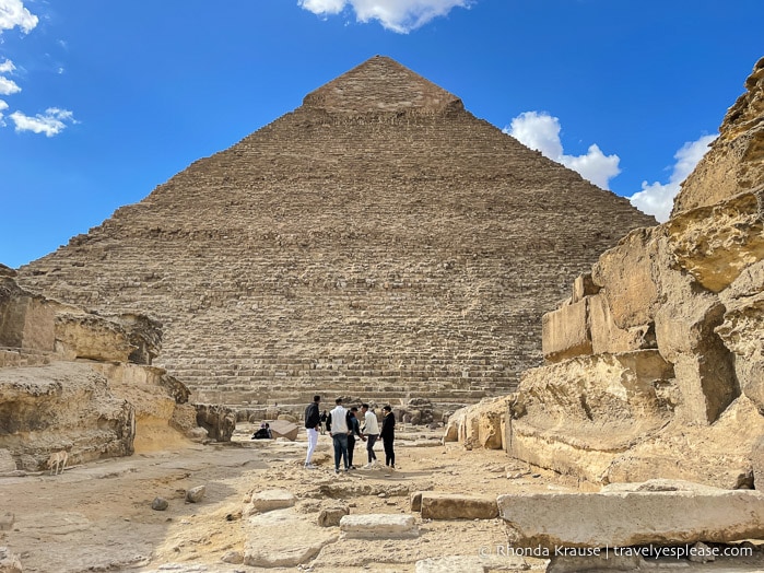 Tourists standing in front of the Pyramid of Khafre.