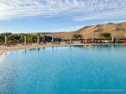 Pool with sand dunes in the background.