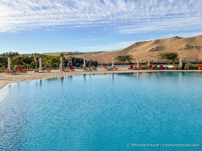 Pool with sand dunes in the background.