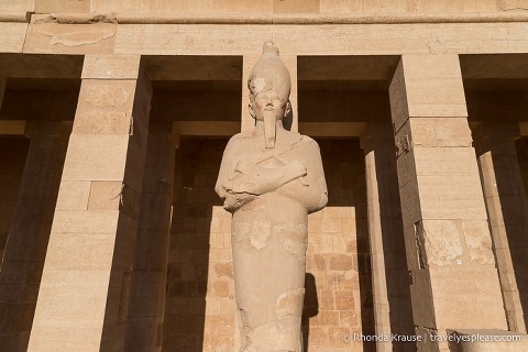 Statue in front of a pillar at Hatshepsut Temple.