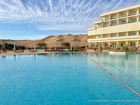 Hotel, pool, and sand dunes in Aswan.