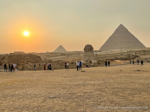 Sunset behind the sphinx and Pyramids of Giza.