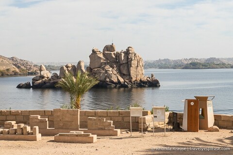 Tourist police booth at Philae Temple with a river and rocky island in the background.
