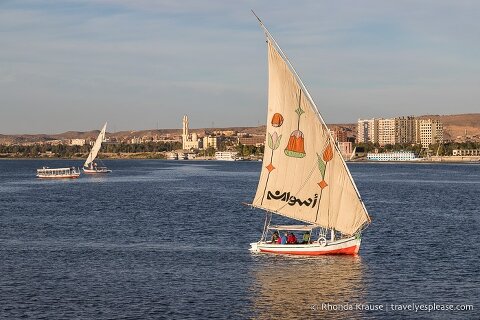 Felucca boat sailing on the Nile River in Aswan.