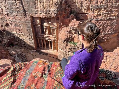 Sitting on the edge of a cliff overlooking the Treasury in Petra.