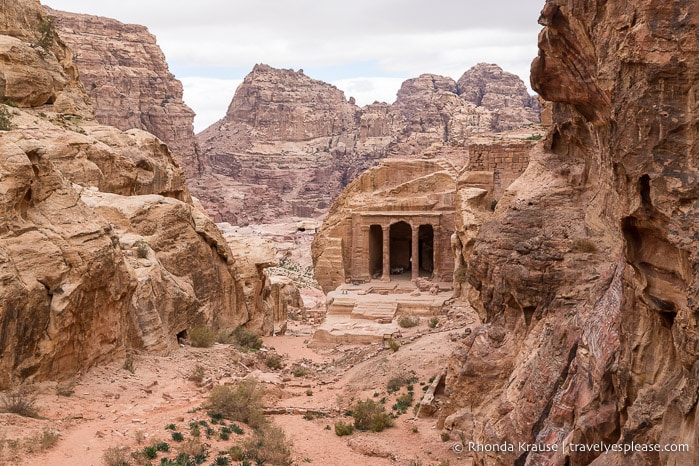 Rock-cut building and mountains in Petra.