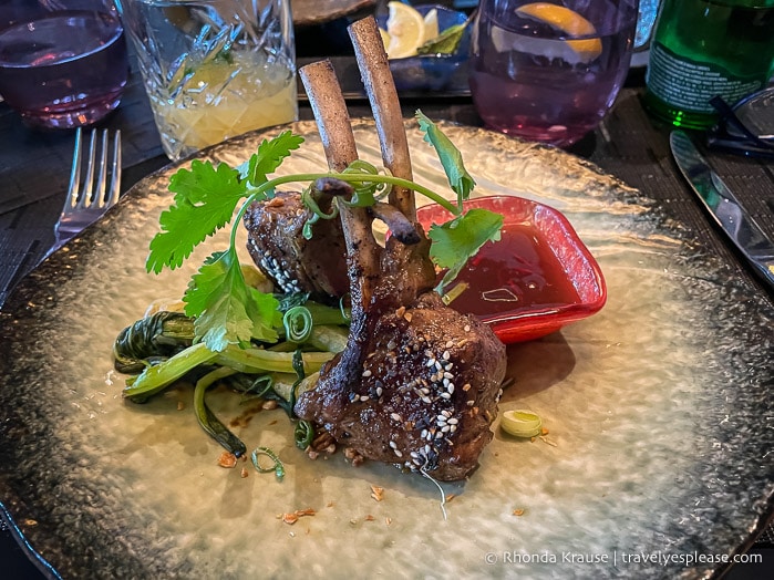 Lamb chops served on a plate.