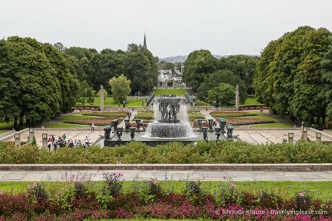 A fountain, flowers, and trees at Frogner Park.