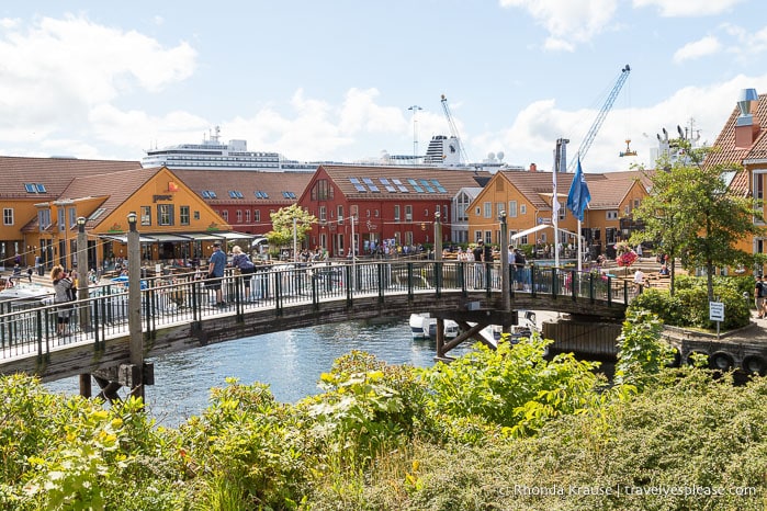 Red and yellow buildings and a canal at the fish market in Kristiansand.