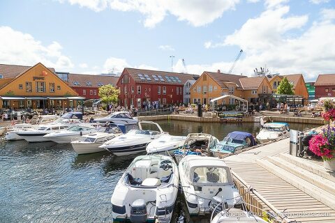 Boats and colourful buildings at the quay by the fish market in Kristiansand.