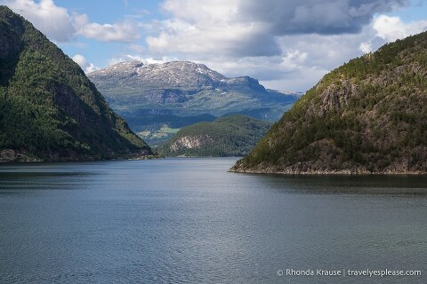 Tree-covered mountains in Hardangerfjord seen while cruising Norway.