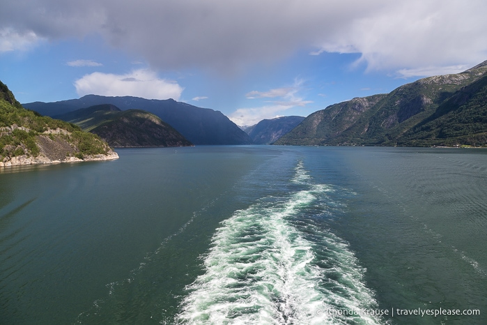 View from the back of a ship while sailing down Hardangerfjord on a Norway cruise.