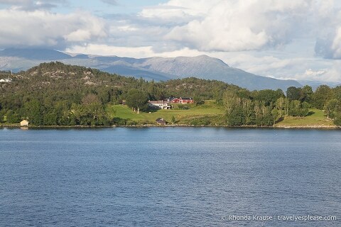 House backed by mountains along Hardangerfjord.