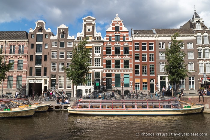 Canal and boat in front of buildings in Amsterdam.