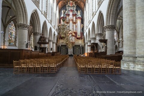 An aisle of chairs leading towards the organ in St. Bavo Church.