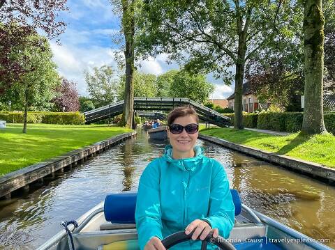 Driving an electric boat down a canal in Giethoorn.