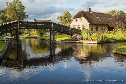 House beside a bridge crossing over a canal in Giethoorn.