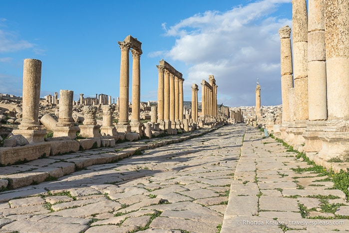 Cobblestone street lined by columns in Jerash.