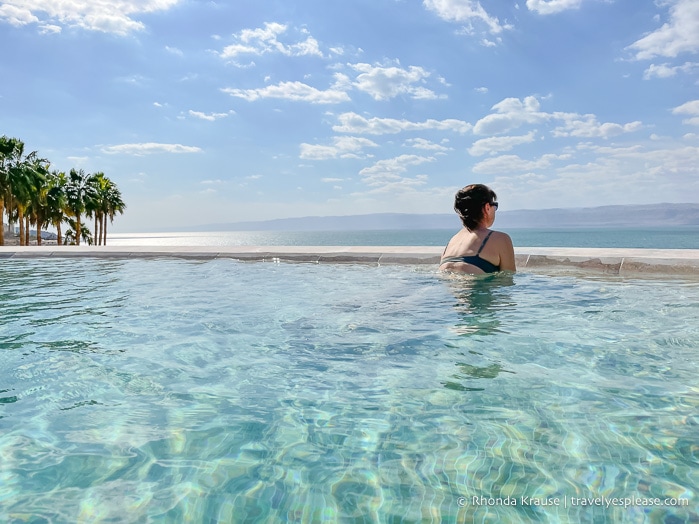 Woman in a pool overlooking the Dead Sea.