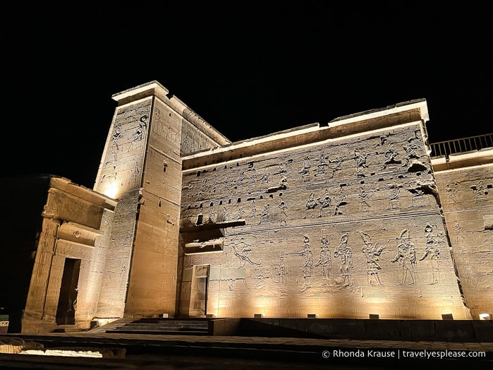 Side of Philae Temple lit up at night.